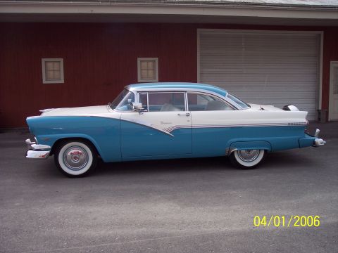 1960 Ford Falcon - A classic two-tone blue and white 1955 Ford Fairlane Crown Victoria is shown from the side.