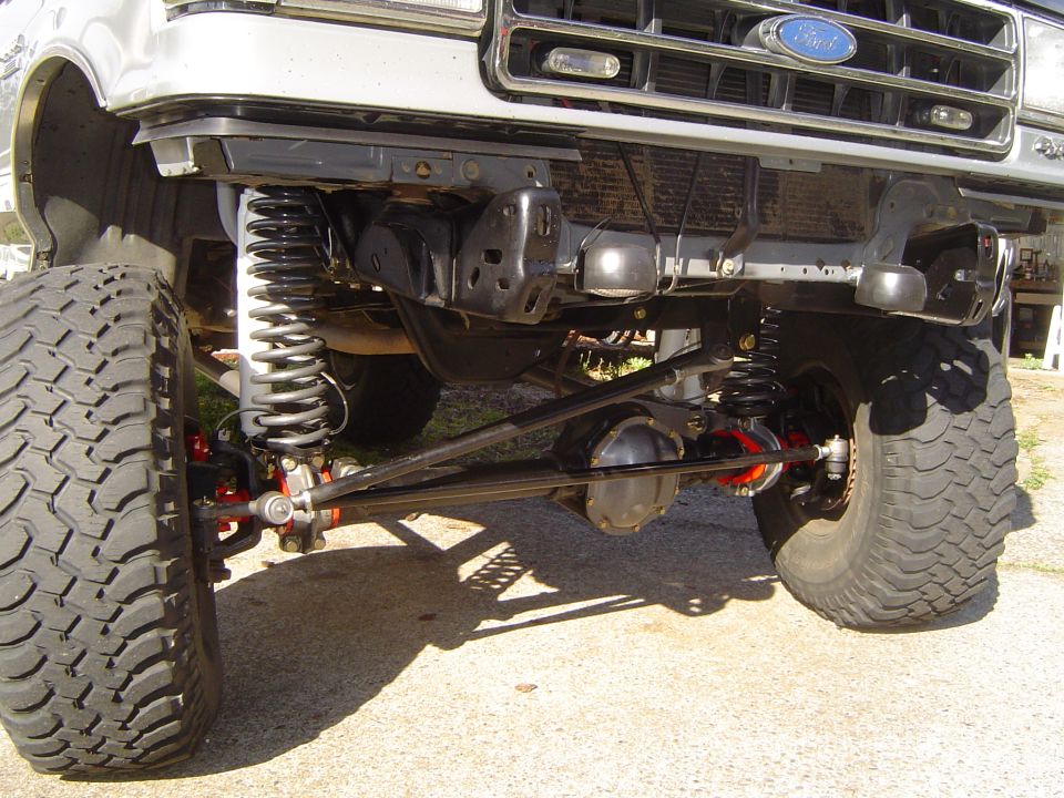 Underside front view of Ford truck with solid axle swap and coil springs