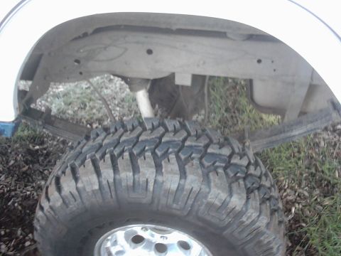 1978 Ford Bronco - Close-up view of the rear leaf spring suspension and tire, with a watermark from Supermotors.net visible.