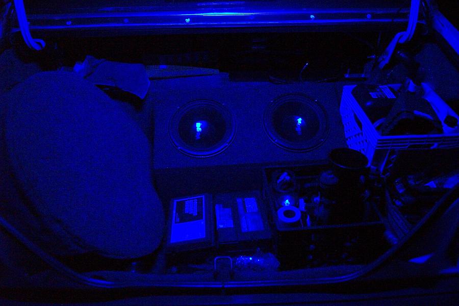 Car trunk interior with two subwoofers, amplifiers, and blue LED lighting