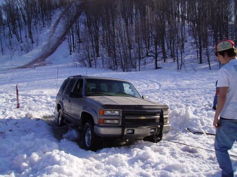 2000 Chevrolet Tahoe - This Chevrolet Tahoe is stuck in a snow drift, with a tow rope attached to the front bumper.
