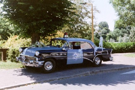 1991 Ford Crown Victoria - This 1956 Buick Century police car is seen from the side with its doors open.