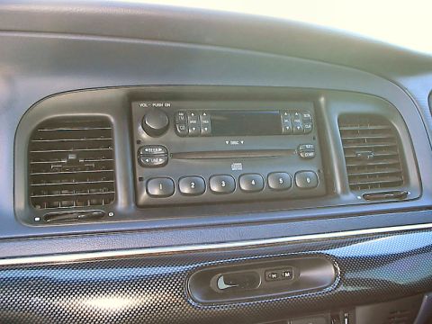 1985 Mercury Grand Marquis - Interior view of a car dashboard, focusing on the radio and climate controls.