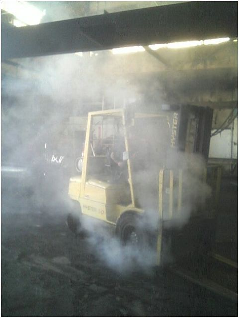 1979 Ford Bronco - A yellow Hyster forklift is seen performing a burnout, kicking up a significant amount of smoke.