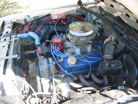 1985 Ford Crown Victoria LTD - The engine bay is filled with aftermarket performance parts, including a Holley carburetor and MSD ignition system.