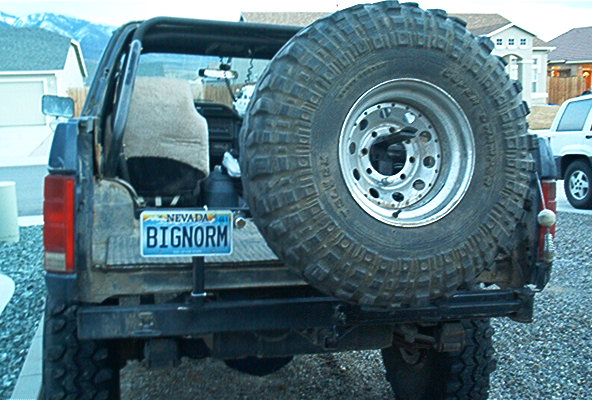Dark blue Ford Bronco rear view with spare tire mounted externally and Nevada license plate reading BIGNORM