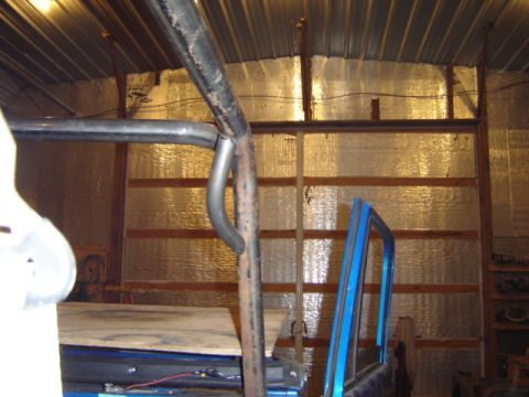1992 Ford Bronco - Interior view showing a blue door frame and a metal roll cage structure.