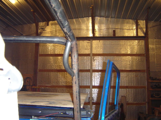 Blue door frame and roll cage inside a structure