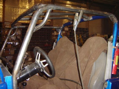 1992 Ford Bronco - Interior view of a custom buggy with a prominent roll cage and brown seat covers.