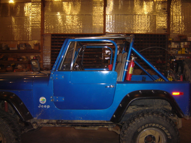 1992 Ford Bronco with roll cage and off-road tires, side view