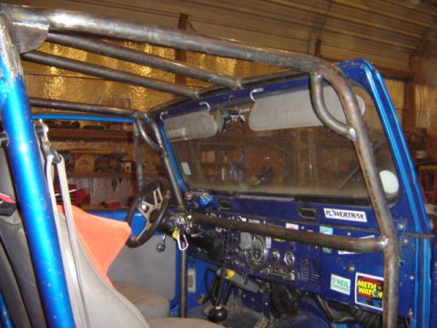 1992 Ford Bronco - Interior of a blue vehicle, showing the dashboard and windshield with some text.