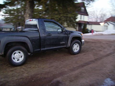 2000 Chevrolet Tahoe - A dark blue Chevrolet Colorado pickup truck is seen from the side in a residential area.