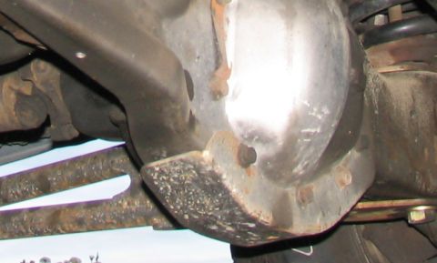 1984 Ford Bronco - Underside view of a vehicle's differential housing and suspension components.