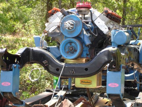 1989 Ford Bronco - Close-up of a Ford engine and chassis components, including a Milodon oil pan and blue pulleys.
