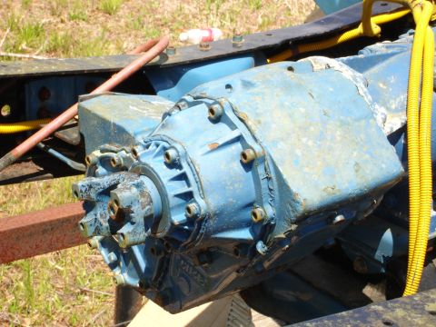 1989 Ford Bronco - Close-up of a blue transfer case assembly, likely from a truck or SUV, with associated wiring and hoses.