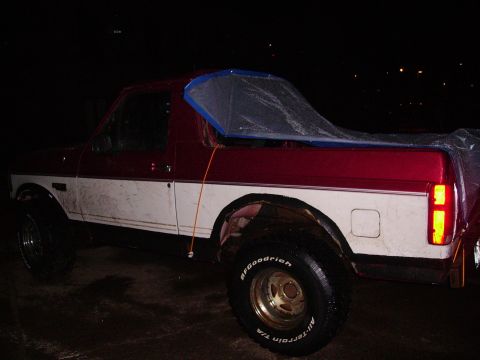 2000 Chevrolet Tahoe - This two-tone pickup truck has a tarp over its bed and BFGoodrich All-Terrain tires.