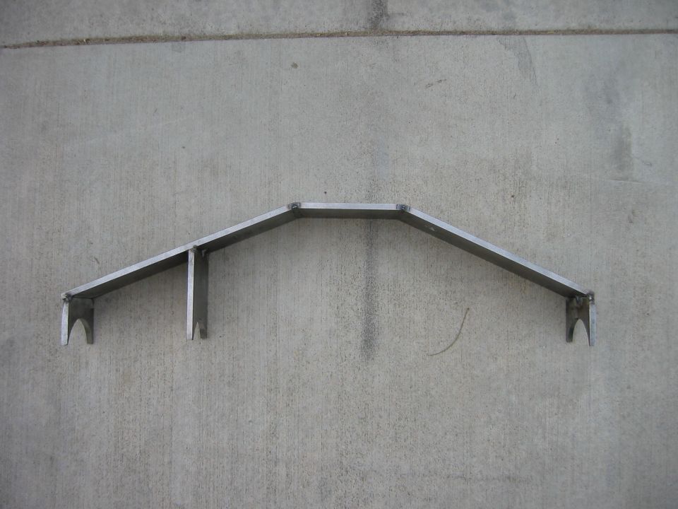 Metal fabrication part mounted on concrete wall