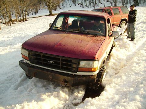 2000 Chevrolet Tahoe - Ford F-Series truck stuck in snow with another vehicle nearby.