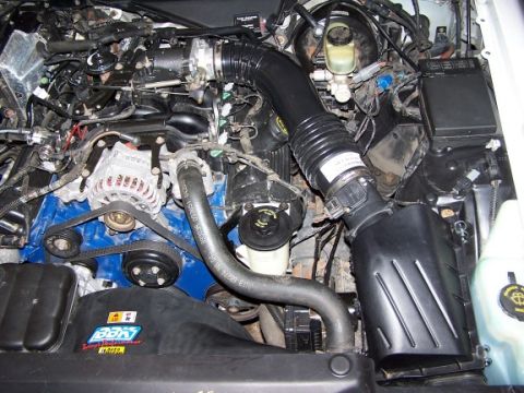 2000 Ford Crown Victoria - Close-up view of a vehicle's engine compartment, showing various mechanical components and wiring.