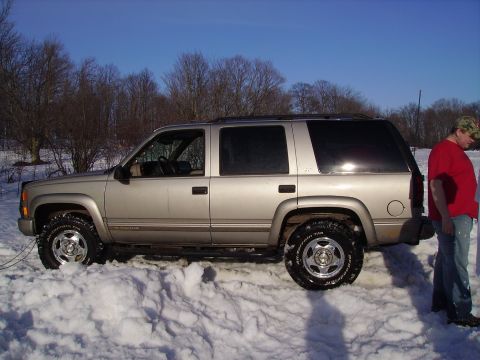 2000 Chevrolet Tahoe - Chevrolet Tahoe seen in a snowy landscape with a person standing nearby.