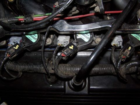 2000 Ford Crown Victoria - This image shows several ignition coils and their associated wiring harnesses, typical of a vehicle's engine compartment.