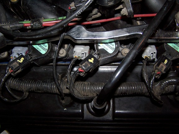 Close-up of engine ignition coils and wiring. Some coils have 'Motorcraft' labels