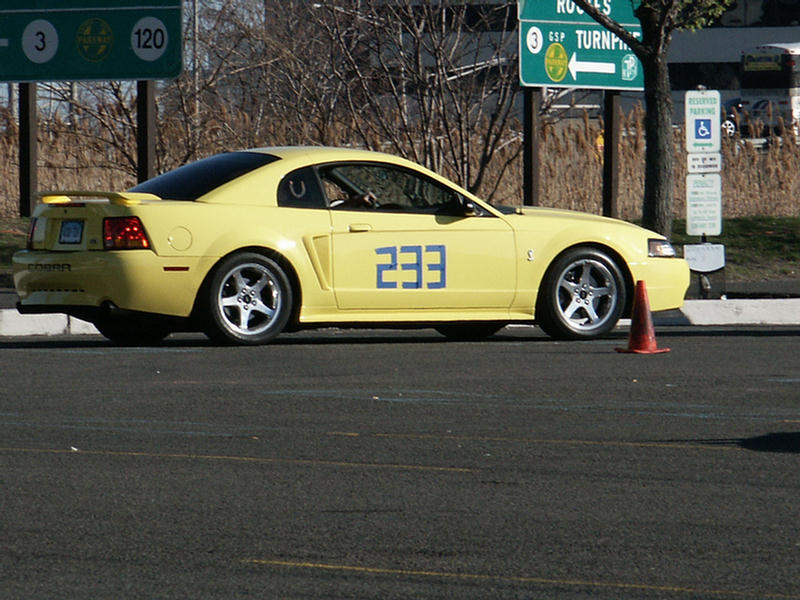 Yellow 2001 Ford Mustang Cobra with number 233 on the door, side view
