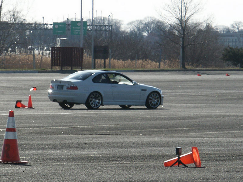 White 2001 Mercury Grand Marquis coupe on a track, rear-left quarter view, with orange cones
