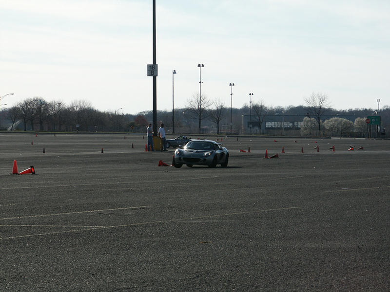 Sports car navigating a cone course in a parking lot