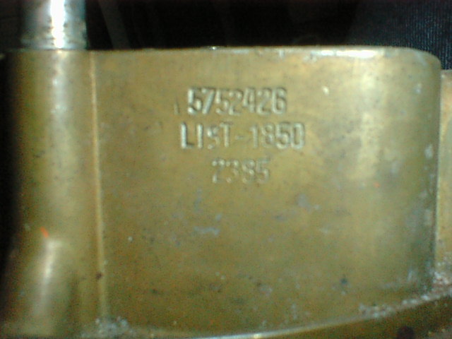 Close-up of a brass casting stamped with numbers 5752426, LIST-1850 and 2386