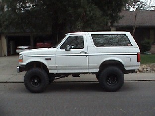 1994 Ford Bronco - This white 1994 Ford Bronco features a 6-inch Super lift and Sky Shackle Flip installation, giving it an aggressive stance.