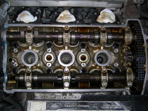1992 Ford Taurus - Close-up view of an engine's internal components, including camshafts and a timing chain. The Ford Motor Company logo is visible.