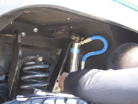 1985 Ford Bronco - Installing a new shock absorber and spring assembly on a vehicle's suspension system.
