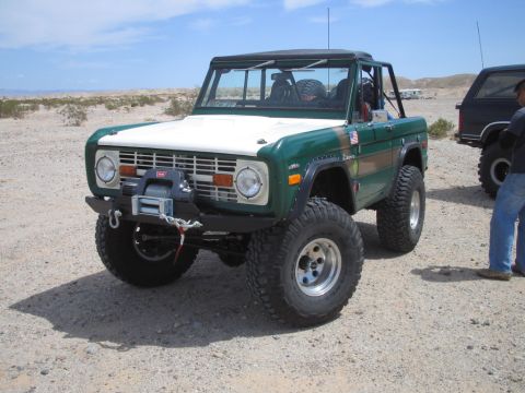 1985 Ford Bronco - This modified Ford Bronco is equipped with off-road tires and a winch, ready for desert terrain.