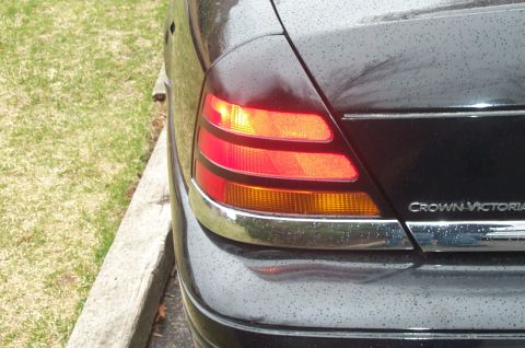 1999 Ford Crown Victoria - Rear view of a 1999 Ford Crown Victoria showing the tail light and 'Crown Victoria' badging.