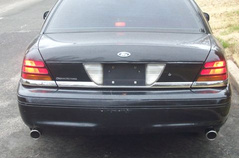 1999 Ford Crown Victoria - Rear view of a black 1998 Ford Crown Victoria, updated blacked out tail lights and chrome trim.