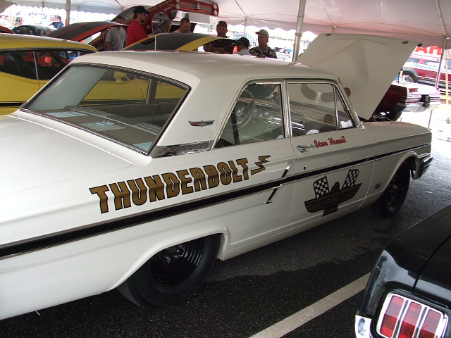 White 1966 Ford Thunderbolt with racing decals and checkered flags