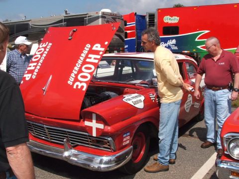 1966 Ford Ranchero - A red 1956 Ford Fairlane, modified for racing, is displayed with its hood open at an outdoor event.