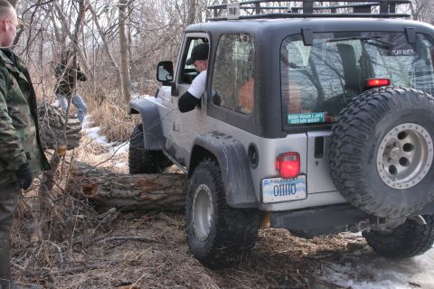 1995 Jeep Cherokee - This Jeep Wrangler appears to be from the early 2000s, not a 1995 model, as it navigates an off-road trail.