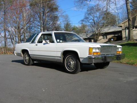 1985 Ford LTD Crown Victoria - White 1985 Ford Crown Victoria LTD sedan with chrome grille and bumper.