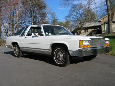 1985 Ford LTD Crown Victoria - This white sedan, likely from the early 1980s, is shown from a three-quarter front angle.