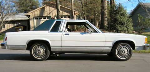 1985 Ford Crown Victoria LTD - This 1985 Ford Crown Victoria LTD is a two-door sedan with a white exterior and a vinyl roof.