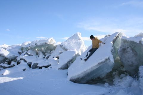 1995 Jeep Cherokee - A person slides down a large ice floe in a snowy landscape.