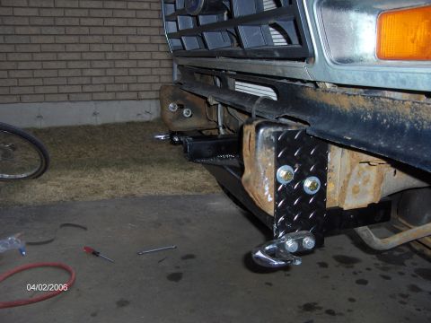 1986 Ford Bronco - A close-up view of a custom-installed front hitch and tow hook assembly on a vehicle.