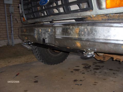 1986 Ford Bronco - A custom front hitch is attached to the bumper of a vintage Ford Bronco.