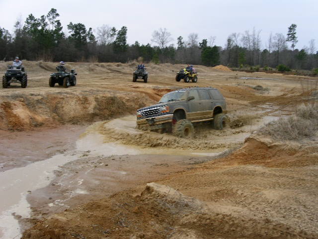 SUV and ATVs playing in mud