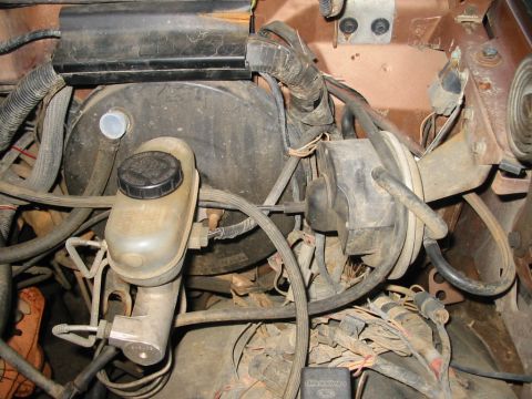 1988 Ford Bronco - Close-up of the brake booster and master cylinder assembly in an engine bay.