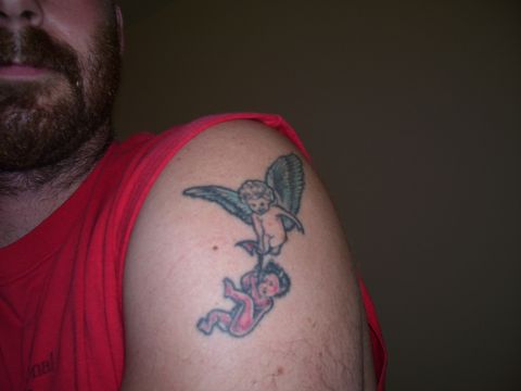 1992 Ford Bronco - A tattoo of two cherubs is visible on a person's shoulder, with a Supermotors.net watermark in the corner.