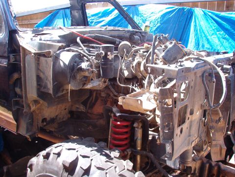 1994 Ford Bronco - Front end of a 1994 Ford Bronco disassembled, revealing the engine and suspension components.