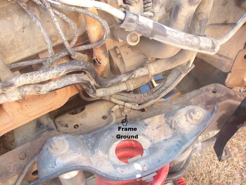 1994 Ford Bronco - Frame ground just inboard of the R spring tower. The black battery wire goes from the front bolt of the engine mount (on the block) to this…